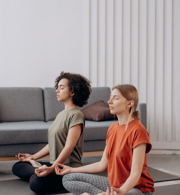 Person practicing a gentle yoga stretch in a bright room.